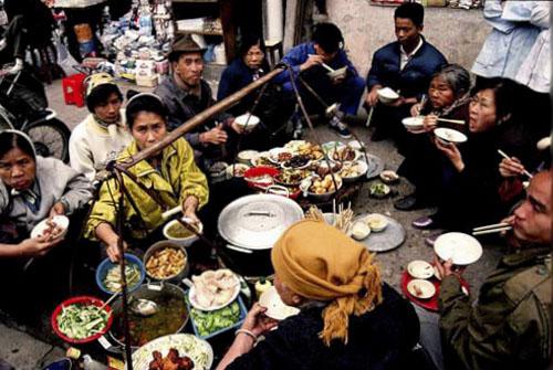 Have food on street sidewalk in Hanoi