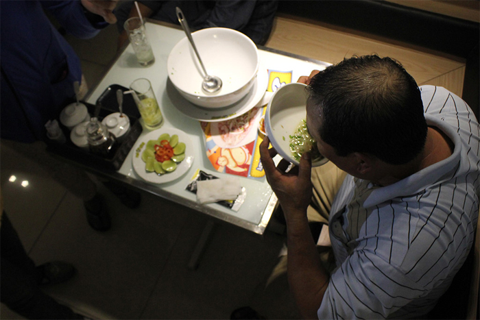 A man is eating the noodles soup in Saigon, Vietnam